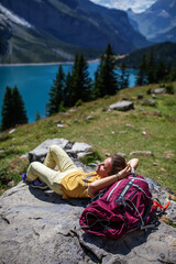 Fototapeta premium Tourist in the mountains in Switzerland on Lake Oeschinensee