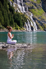 A woman practices yoga in the mountains