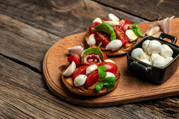 Healthy Grilled Basil Mozzarella Caprese Panini Sandwich on a wooden background. Delicious breakfast or snack, Clean eating, dieting, vegan food concept. top view