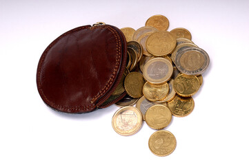 Different euro coins coming out of wallet