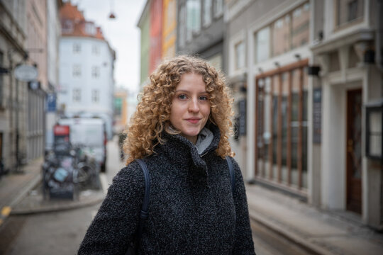 Portrait of a young scandinavian girl in the city center during a winter day.
