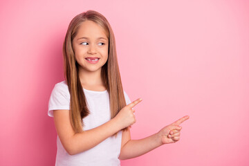 Portrait of positive cheerful person look indicate fingers empty space blank isolated on pink color background