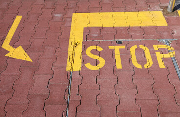 Stop and arrow sign at the road crossing