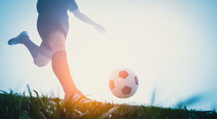 Football soccer player shooting a ball on goal - obrazy, fototapety, plakaty
