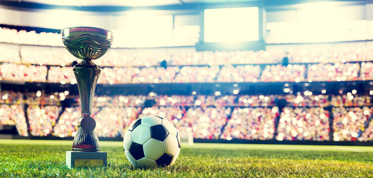 Football Soccer Ball And Trophy Cup On Stadium