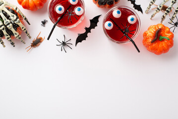 Halloween concept. Top view photo of drink in glasses with floating eyeballs and spiders pumpkins...