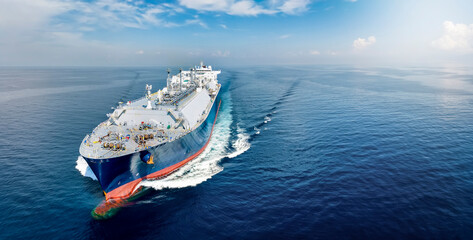 Front view of a big LNG tanker ship traveling with full speed over the calm, blue ocean as a concept for international fuel industry with copy space - 527831941