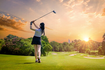 Professional woman golfer teeing golf in golf tournament competition at golf course for winner	