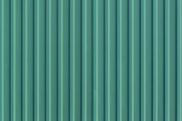Green profiled sheeting close up. wall with embossed background texture. corrugated board.