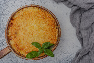 Lasagna with mozzarella and parmesan on a gray background