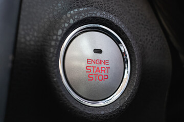 Gray start stop engine button with chrome trim