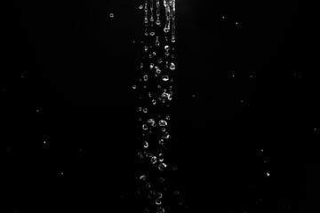 water splashes isolated on black background. white jets with drops