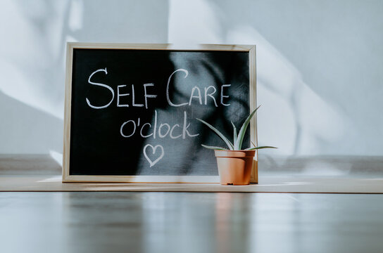 Chalkboard with Self Care o'clock hand written message