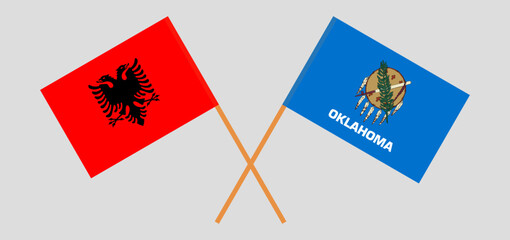 Crossed flags of Albania and The State of Oklahoma. Official colors. Correct proportion