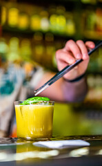 man hand bartender making cocktail in glass on the bar counter