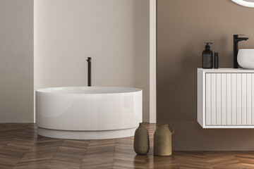 Naklejka na ściany i meble Beautiful oval bathtub wiht black faucet standing on parquet in modern bathroom. 