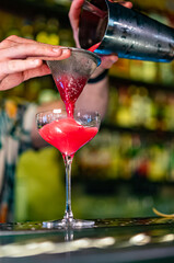 man hand bartender making sweet and sour refreshing cocktail on the bar counter