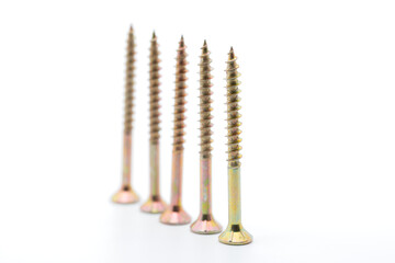 Fototapeta premium Screws in a close up from the side, wood screws, white background, cropped image