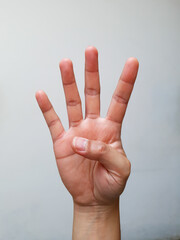 Naklejka premium hand with four finger gesture on a white background