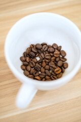 Roasted coffee beans inside the cup