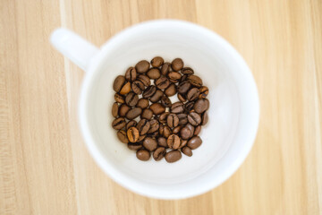 Roasted coffee beans inside the cup
