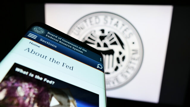 Stuttgart, Germany - 08-27-2022: Smartphone with website of United States Federal Reserve System (Fed) on screen in front of seal. Focus on top-left of phone display.
