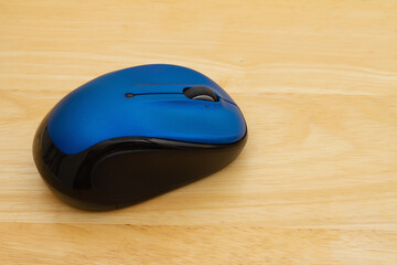 Blue mouse on a wood desk