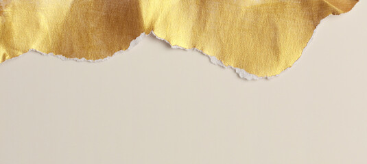 Gold torn empty pieces of texture paper on light beige copy space background.