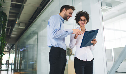 Millenial business man and woman working in office