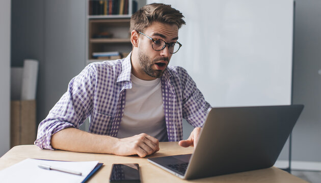 Millennial Businessman Working At Desk In Office