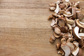 Top view of cut and dried medicinal birch polypore mushrooms on wooden cutting board, used in alternative medicine. With ample copy space.