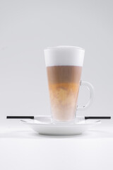 tasty italian latte coffee with straw and saucer isolated on white background