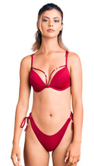 Obraz premium Young beautiful woman wearing bikini looking sleepy and tired, exhausted for fatigue and hangover, lazy eyes in the morning.