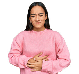 Young asian woman wearing casual winter sweater with hand on stomach because indigestion, painful...
