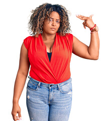 Young african american plus size woman wearing casual style with sleeveless shirt shooting and killing oneself pointing hand and fingers to head like gun, suicide gesture.