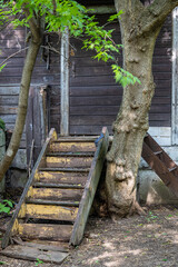 Old wooden staircase in front of the entrance to the house