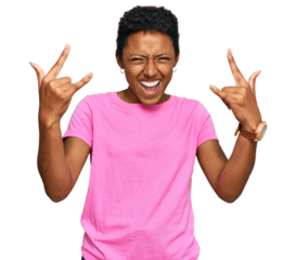 Young african american woman wearing casual clothes shouting with crazy expression doing rock symbol with hands up. music star. heavy music concept.