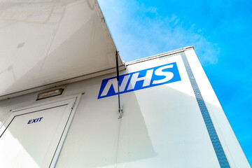 Abstract view of a British health service logo seen on a mobile cancer screening unit trailer....