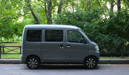 A new gray minivan is parked at the Green Park, Iskrovsky Prospekt, St. Petersburg, Russia,...