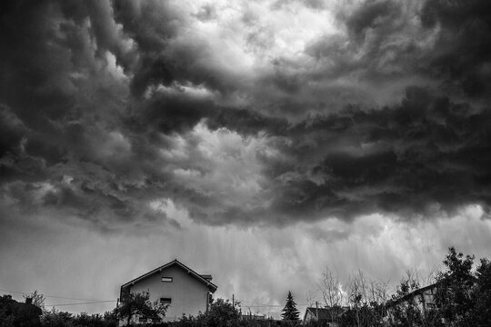 Dark stormy clouds over house