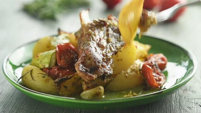 The cook tastes the greek roasted lamb with potatoes.
