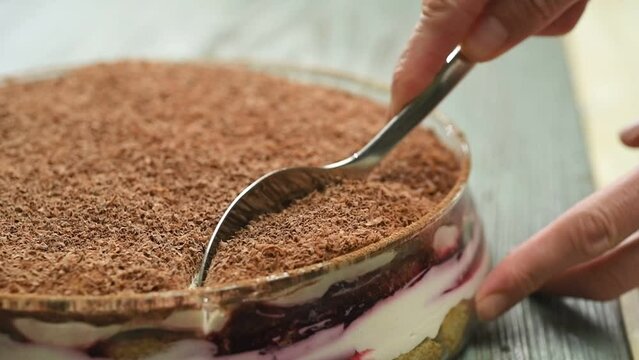 The chef takes a spoonful of the sour cherry tiramisu.
