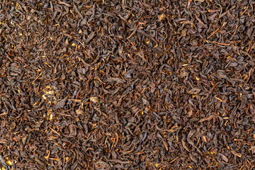 Background for a cafe or restaurant, black leaf tea close up, tea advertising. Texture