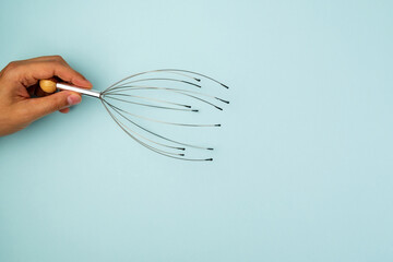 Manual massage for the head device. Allows you to relax and get rid of stress. Blue background