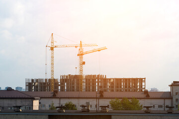Construction cranes, construction site. The house is under construction. Copy Space