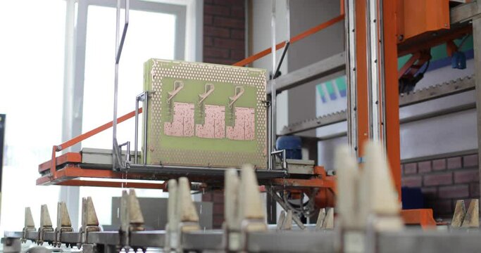 Process of immersion diving of microchips circuit boards in solution in production on factory using automatic equipment. Manufactoring of electronic microcircuits and chips. High-tech technologies.