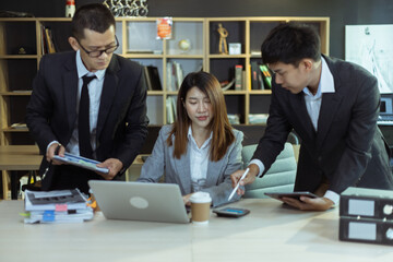 Technology and financial advisory services concert. Business teamwork and working on digital laptop computer with advisor showing plan of investment to clients at table office. Digital marketing.