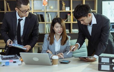 Technology and financial advisory services concert. Business teamwork and working on digital laptop computer with advisor showing plan of investment to clients at table office. Digital marketing.
