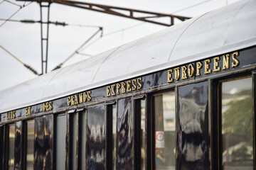 Famous Orient Express long distance passenger train stopped in Bucharest central train station. - obrazy, fototapety, plakaty