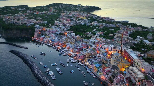 famous Italian island of Procida in the evening, Italian seaside resort, tourist destination near Naples, Italy, aerial view of fishing village on Procida with evening lights